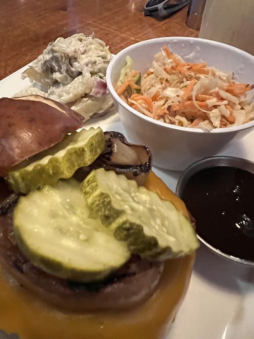 Jackfruit burger with vegan sides   at Aroma Thyme Bistro in Ellenville