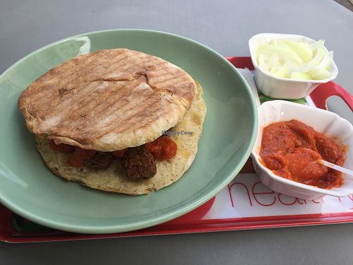 Ćevapi in flat bread with onion , the traditional side dish for Ćevapi. at Vege Fino Za Sve in Zagreb