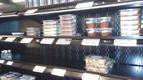 Cold case with desserts, elixir shots, and pre-made salads at Rooted Juicery + Kitchen - Madison Rd in Cincinnati