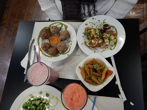 baked potatoes with skin and salt + delicious sauce, homemade tortilla chips and guacamole, fresh bruschetta, vegan pizza, milkshake and fresh juice.  at The Mantraa in Barcelona