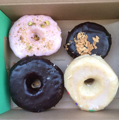 best yeasted donuts! rosewater pistachio, dark chocolate glaze, glaze, and dark chocolate ganache filled almond donut. at O Face Donuts in Las Vegas