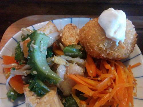 A side-dish featuring crumbed tofu, bitter melon and cashew (?) cream cheese. at Veggie Syokudo Funadeya in Fukuoka