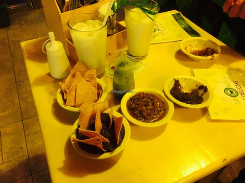 Best spicy salsa in Cancun! Delicious black refried beans. The green sauce in the bottle is super spicy and amazing! at Las Delicias Fonda Vegana y Vegetariana  in Cancun