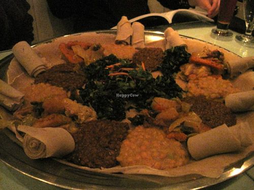Vegetarian platter for 4 people : injera bread, split peas (yekik alicha), potatoes, carrots and cabbage (yatakelt watt), spinach (gommen) and lentils in spicy sauce (yemesser watt). Small salad in the centre.

Very good choice. at Le Nil Bleu in Montreal