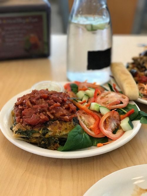 Spinach Butternut Squash lasagna. Made with tofu ricotta and topped with fresh chunky marinara. Served with a salad (spinach, tomato, carrot, cucumber, bell pepper) and house dressing.  at Wild Rabbit Cafe and Health Bar in Flagler Beach