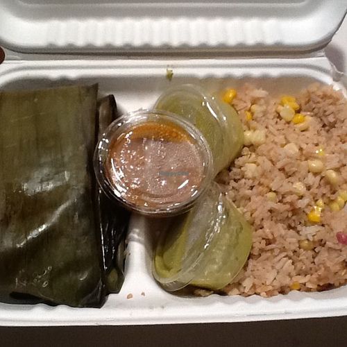 Banana leaf wrapped tamales, fungi rice & salsa/sauces in containers. at Guudbelly in Houston