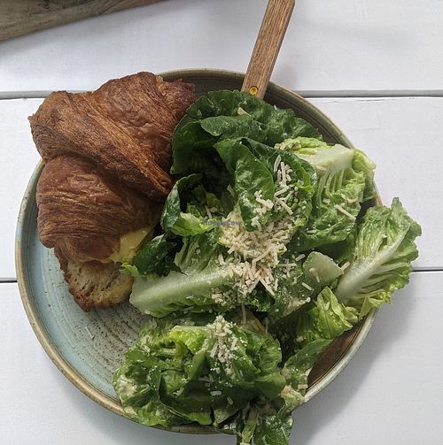 Special du jour: egg, sausage, and cheese croissant sandwich with a side salad at Little Pine in Los Angeles