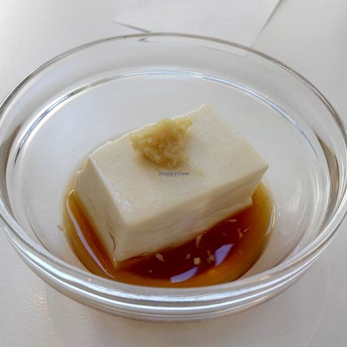 The cold tofu (I already ate half of it). 
Surprisingly very nice. Tofu has a nice texture and  goes well with the dash of ginger on top of it. But it's the soy sauce that makes this dish so wonderful - it has a delightful yuzu (citrus) flavor. at Momi Cafe in Kyoto