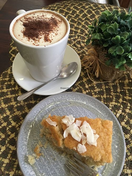 Coconut cake with Hot chocolate  at Dona Flor Cafe in Cascais