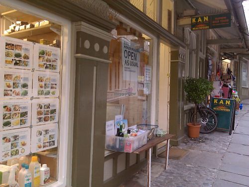 The shop in its little alley. They were having a bit of renovation done, hence the 'Open As Usual' sign. at KAN Healthfoods in Kendal