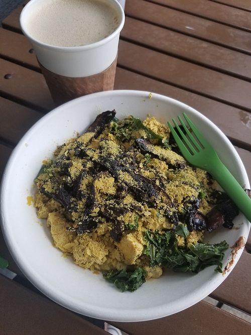 Cheezy grits with tofu scramble, kale, and mushroom bacon at Gnome Cafe in Charleston