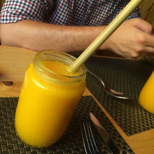 fresh mango juice with their famous bamboo straws  at Jalus Vegan Kitchen in Hanoi