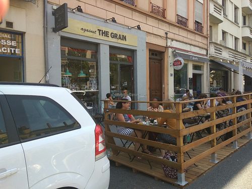Shop front and outdoor seating at Against the Grain in Lyon