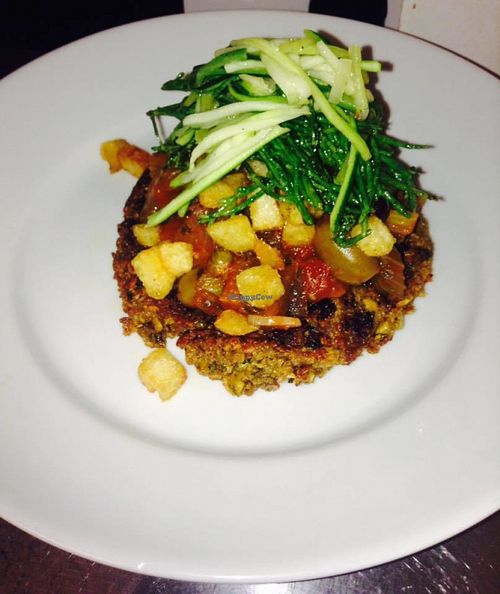 Spicy chickpea cake with caponata, crispy fried potatoes, courgette spaghetti and samphire. at The Vittoria in Bristol