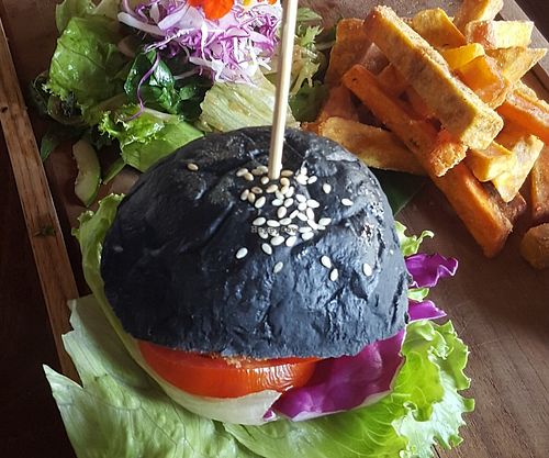 Burn out burger on a charcoal bun. A must try! at Pels Supershop in Tibubeneng