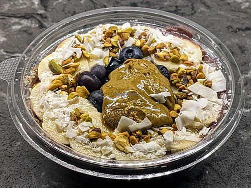 Acai, pistachio butter, banana and plant milk blended together, topped with blueberries, pistachio butter, coconut, banana and pistachio granola at Juice Generation - FiDi in New York City