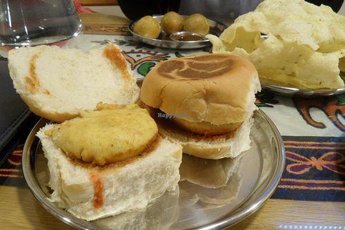 Muttary Kachori on the back (crispy pastry balls with spiced peas inside), Home-made rice poppadom, Bombay Wada Pav (sandwich with potato burger) at Vegetarian Food Studio in Cardiff