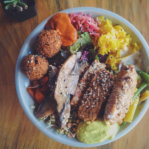 Abundance lunch bowl featuring tempeh, mushrooms, sprouts, krauts, greens and epic sauces. at Sexy Food in Western Cape