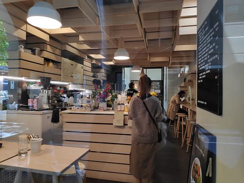 Cute interior, A few small tables and bench with stools at Hunters' Roots in Melbourne