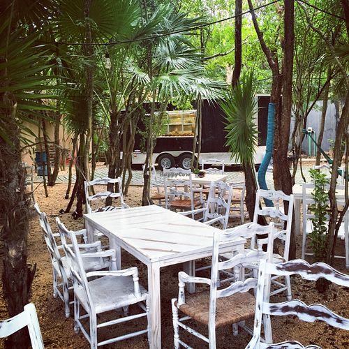 Table area in Jungle with Truck in Background at Charly's Vegan Tacos - Food Truck in Tulum