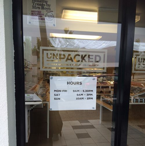 opening hours and a glimpse of the store at Unpacked  in Kingston