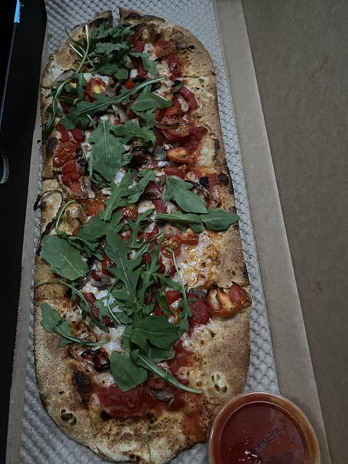 Vegan pizza topped with pepper, mushroom, tomato, arugula  at &pizza - U St in Washington