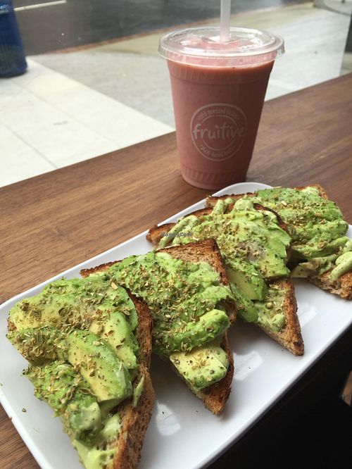 Avocado Toast with basil/avocado pesto - smoothie on the side... at Fruitive - Palmer Alley in Washington