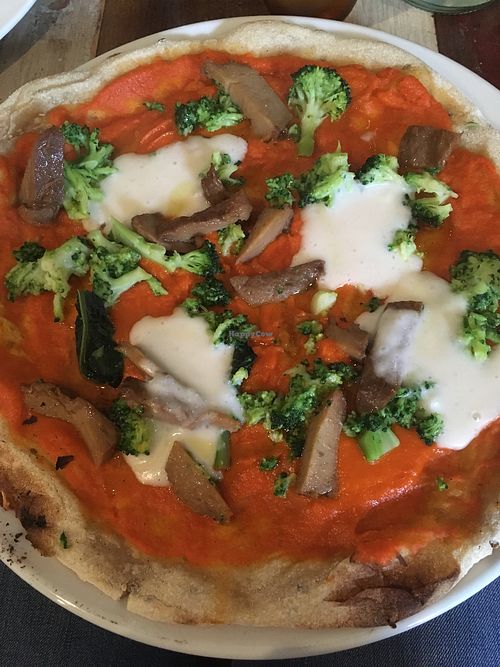Multigrain pizza with tomato sauce, rice cream, seitan and broccoli at L'Orto Gia Salsamentario in Turin
