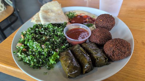 Veggie plate (sub spanatopika for more falafel) with a side of spicy hummus, tabouleh, and fluffy pita at Sahara Greek & Lebanese Cafe in Tallahassee