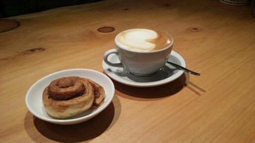 Coffee and cinnamon bun at Naturalley Organic Cafe in Dunedin