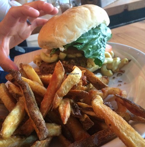 Mac and cheeze burger. hand for size comparison  at MeeT in Gastown in Vancouver
