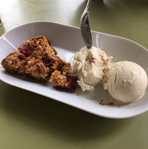 dark chocolate pistachio and raspberry flapjack with vegan ice cream  at Goat Cafe in Huddersfield