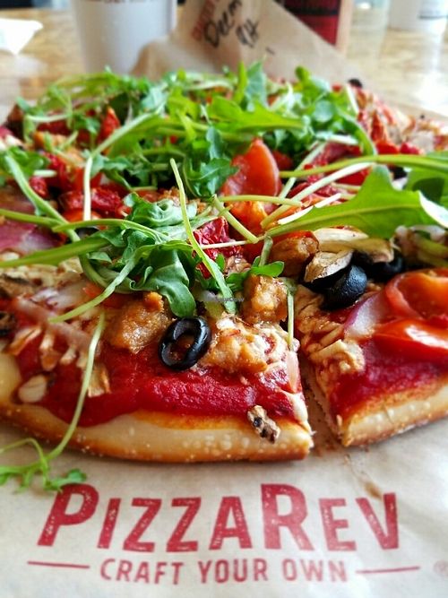 Rocket, Sun-dried tomatoes, onion, mushrooms, olives, tomatoes, vegan sausage, vegan cheez, peppers at PizzaRev in Bakersfield