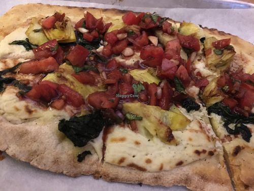 Creamy artichoke tomato basil crudo with garlic cashew cheese and spinach on gluten free (vegan!) crust at Double Zero in New York City