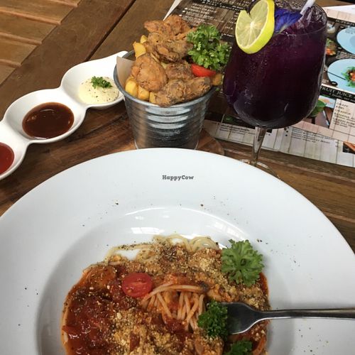 delicious spaghetti, ";chicken"; wings, fries and butterfly pea and lemon drink at Veganerie Concept - Benjasiri Park in Bangkok