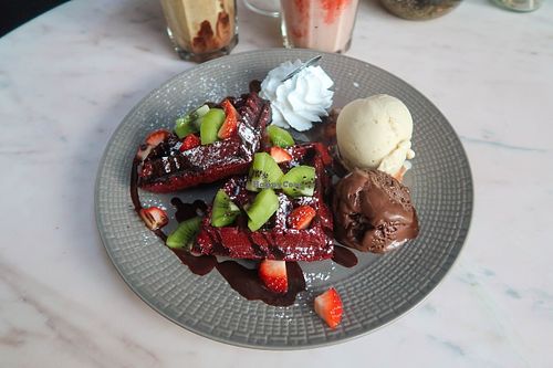 Red velvet waffles with vanilla icecream and brownie icecream. Not enough chocolate sauce, waffles are just plane tasting waffles, but the icecream is amazing! at Veganerie Concept - Benjasiri Park in Bangkok