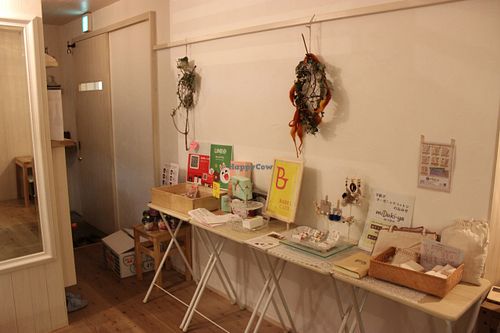 Tiny shop inside Babel Cafe with right->left things made from organic cotton, hand-made jewellery and boxes for cake to take away. at Babel Cafe in Osaka