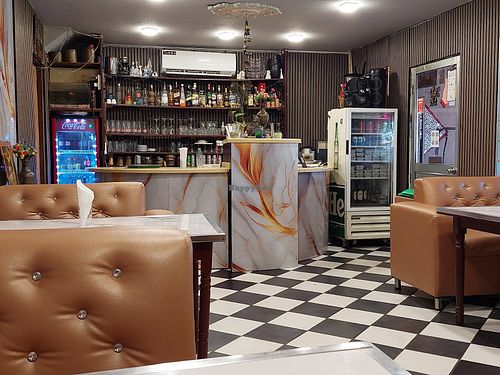 Indoor seating with a/c and strong smell of cigarette! at Martin's House of Indian Food in Paramaribo