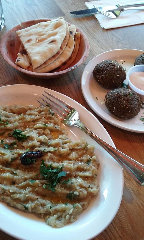 Two orders: eggplant salad (which comes with pita bread - non vegan, has milk) and side order falafel balls (which come with a non vegan, dairy based sauce) at Hummus Mediterranean Cuisine in San Mateo