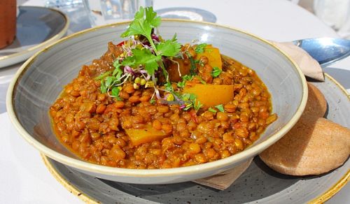 Brown lentil and yellow pepper Dahl curry with wheat free buchetta bites. at Bhuti in Richmond Upon Thames