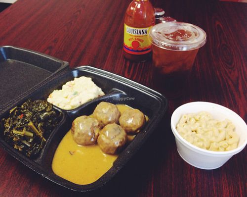 Pecan patty medallions, southern greens, potato salad, Mac and cheese, and sweet tea.  at The Roost Southern Kitchen in Huntsville