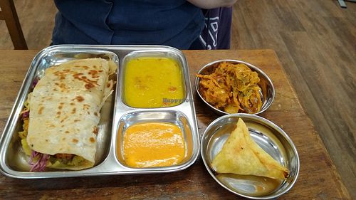 Stuffed Paratha with sides of onion bhaji and samosa at Thenga Cafe in London