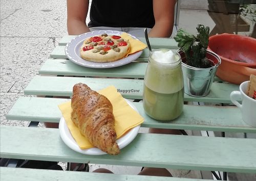 Croissant filled with cream (1,50€), matcha latte (3€), foccacia (2,50€) at Dulcamara Bio Vegan Bistrot in Verona
