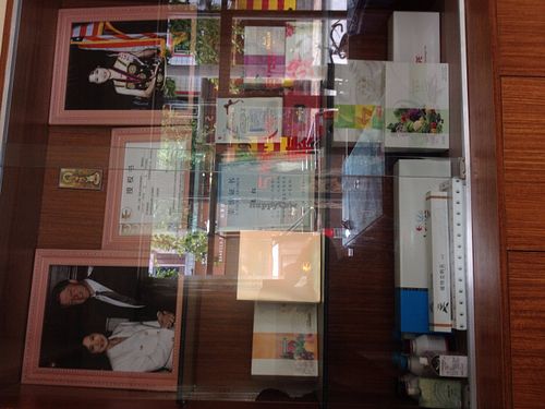 Health items for sale, plus pictures of accomplishments. at Jù Cái Sù Diàn in Tibet