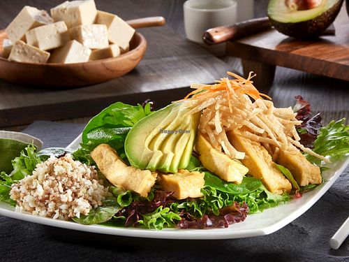 Saucy Tofu Salad: Ginger braised tofu, avocado, crispy wonton crisps, shredded carrots, organic field greens and black bean sauce at Yugo in Miami