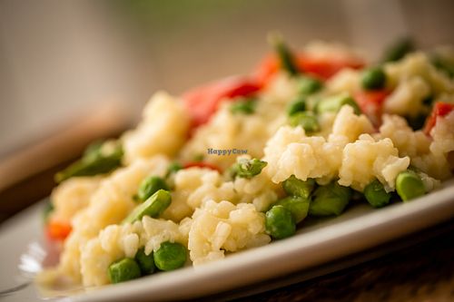 Arborio rice is seasoned with minced onions and garlic and slow cooked with homemade vegetable stock, topped with flash steamed vegetables. at Fred and Ricky's Plant Delicious Foods - Westport in Maryland Heights