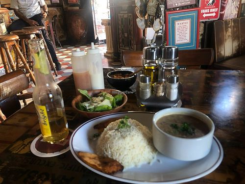 Pinto beans and rice. Salad with cheese on it :( at Charlie's Bar & Restaurant in San Nicolas