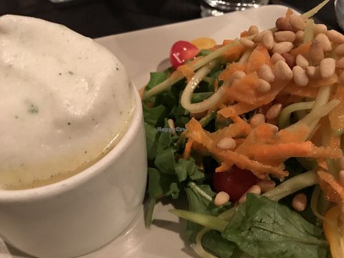 Cauliflower soup with herbal foam alongside the melon and arugula salad with julienne carrots and cucumbers topped with pine nuts at Harvest Beat in Seattle