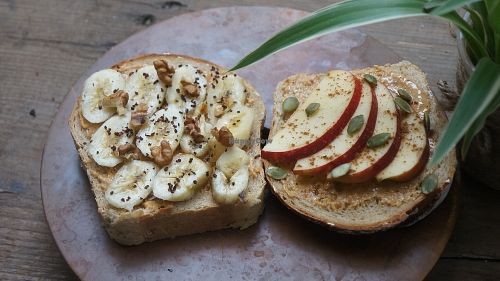 fruit toast with homemade peanut butter, banana, apple and nuts on whole wheat bread at La Studio in Hanoi