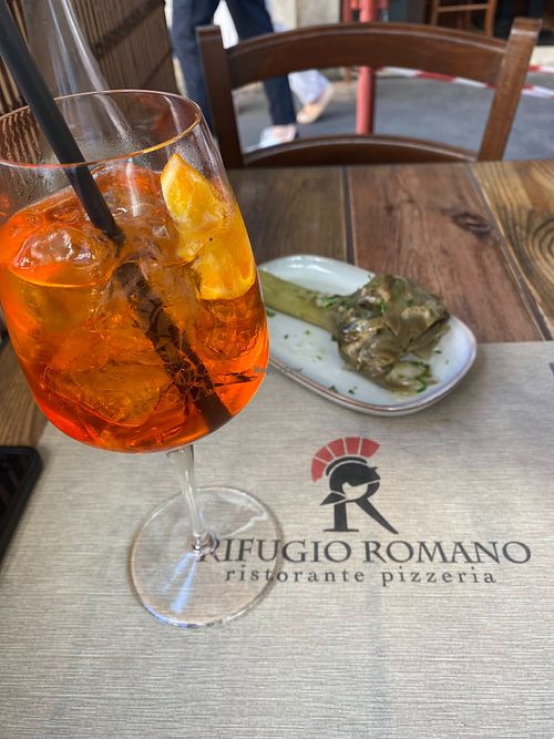 Aperol spritz and Roman-style artichoke at Rifugio Romano in Rome